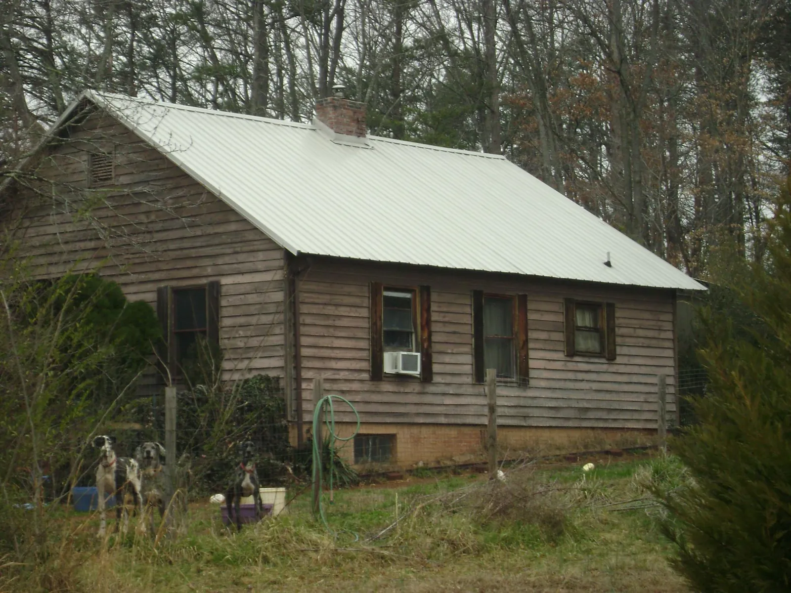 White metal roof on an old wood sided farmhouse, from a Metal Roof Installation job in Apollo